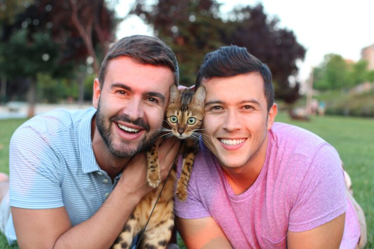 Gay couple in the park with their pet